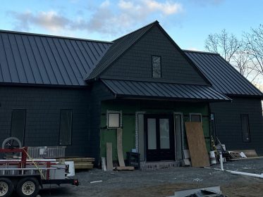 After image of a new construction project showcasing the completed roof trusses.