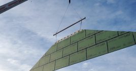 A roof truss being lifted into place during installation.